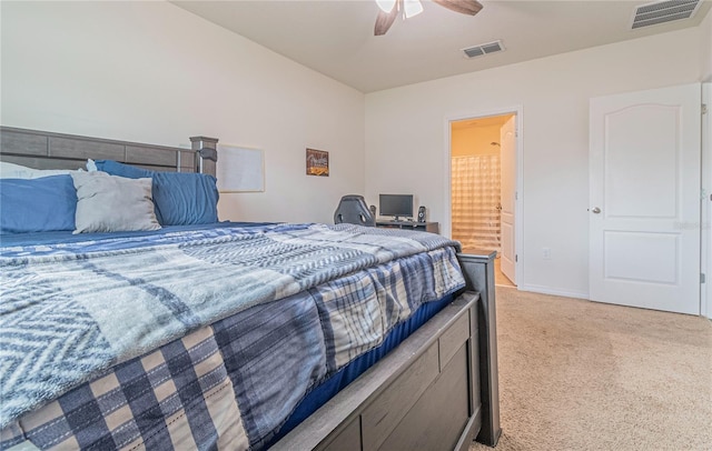 carpeted bedroom with connected bathroom and ceiling fan