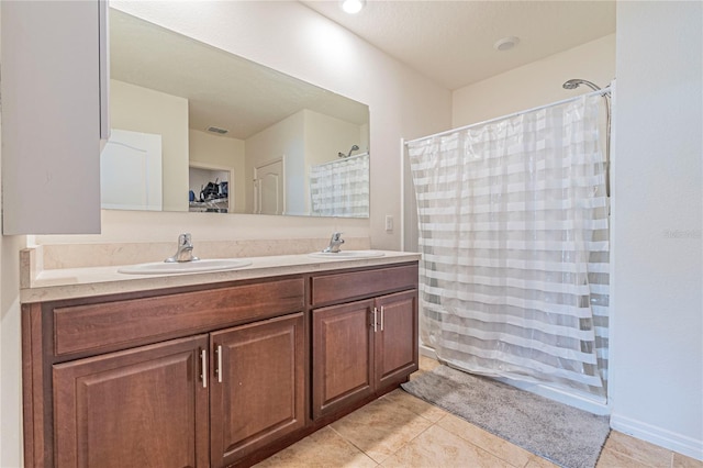 bathroom featuring tile patterned flooring, vanity, and a shower with shower curtain