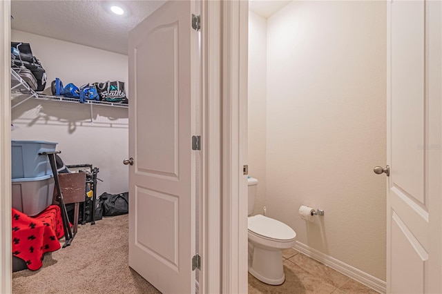 bathroom with a textured ceiling and toilet