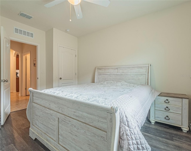 bedroom featuring ceiling fan and dark hardwood / wood-style flooring