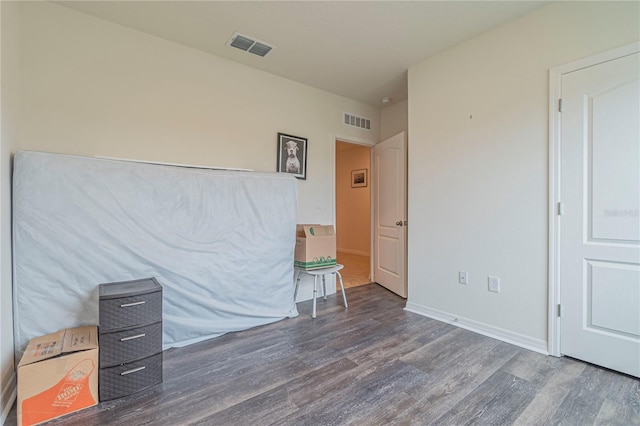 unfurnished bedroom featuring dark hardwood / wood-style flooring