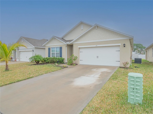 view of front of property featuring a front yard, a garage, and central AC unit