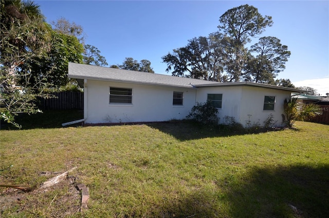 back of house with a lawn