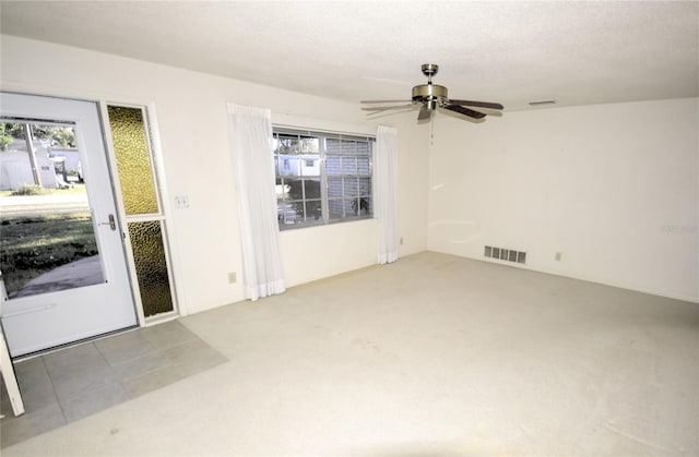 unfurnished room featuring ceiling fan and a textured ceiling