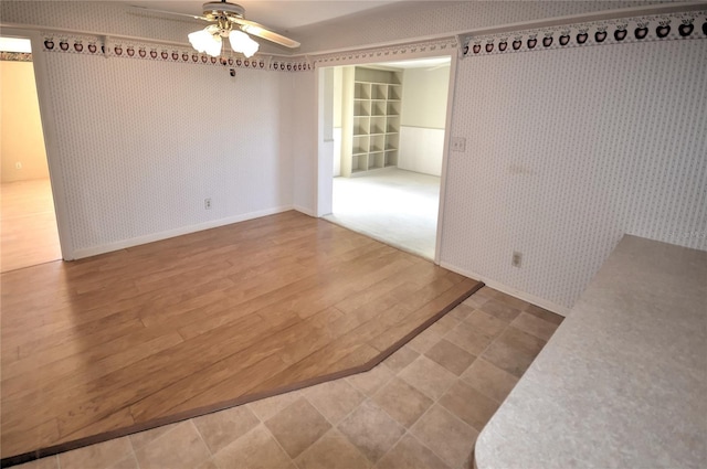 unfurnished room with ceiling fan