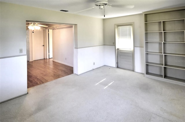 spare room featuring carpet floors and ceiling fan