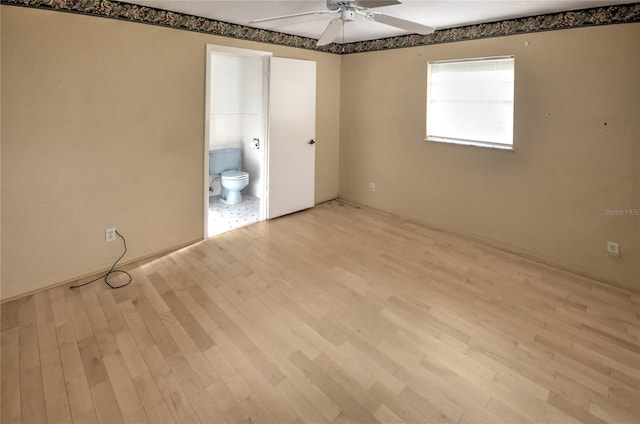 spare room featuring light hardwood / wood-style floors and ceiling fan