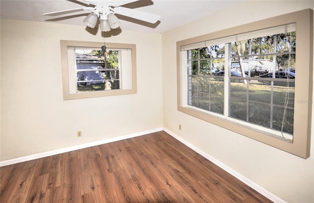 empty room with hardwood / wood-style flooring and ceiling fan