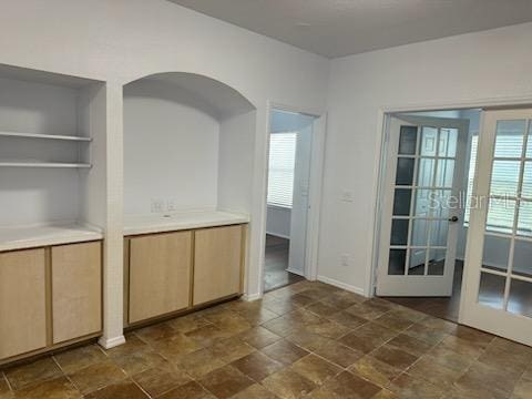 unfurnished dining area with french doors and a wealth of natural light