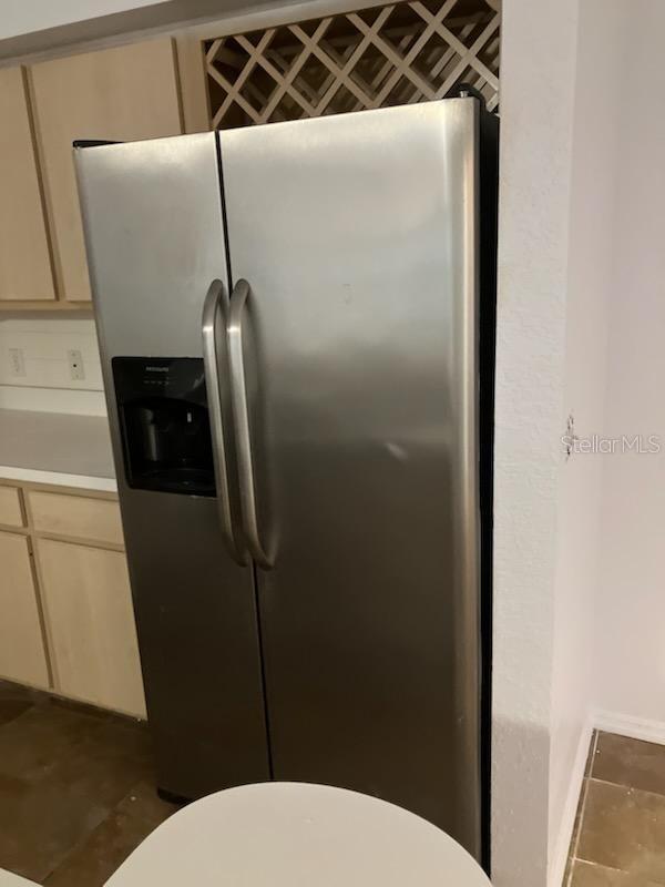 kitchen featuring stainless steel refrigerator with ice dispenser