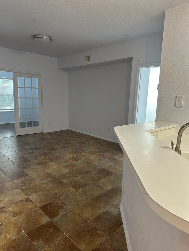 unfurnished living room featuring a textured ceiling