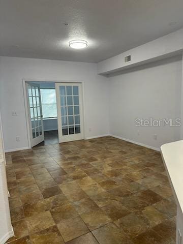 spare room featuring french doors