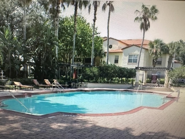 view of swimming pool with a patio