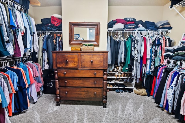 walk in closet with carpet flooring