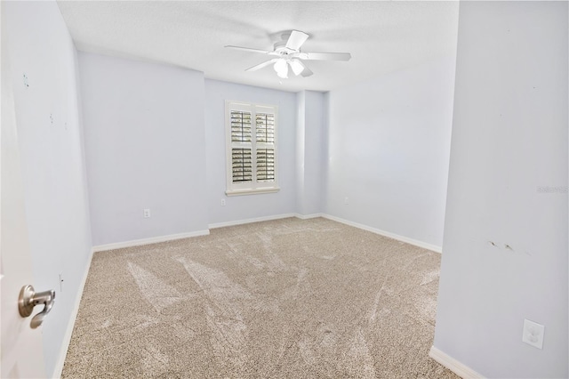 unfurnished room featuring ceiling fan and carpet floors