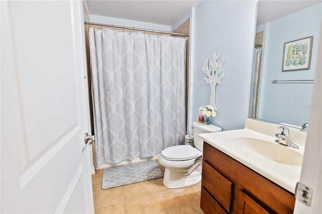 bathroom with vanity, tile patterned flooring, toilet, a textured ceiling, and curtained shower