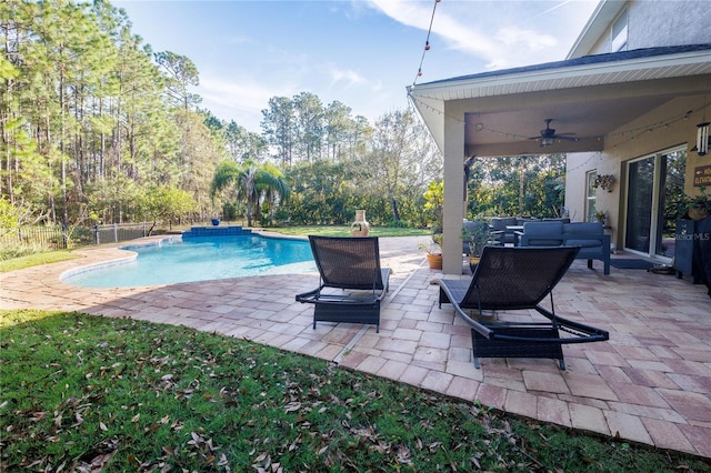 view of swimming pool with an outdoor living space, pool water feature, ceiling fan, and a patio area