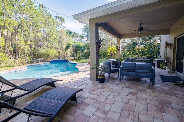 view of pool featuring a patio, an outdoor living space, pool water feature, and ceiling fan