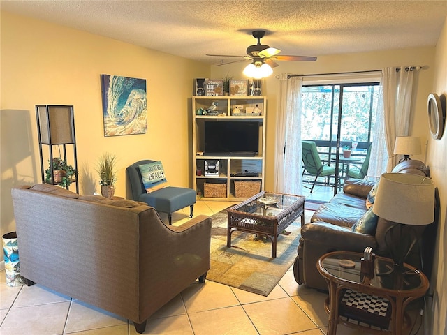 tiled living room featuring ceiling fan and a textured ceiling