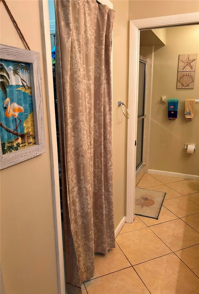 bathroom with tile patterned flooring and walk in shower