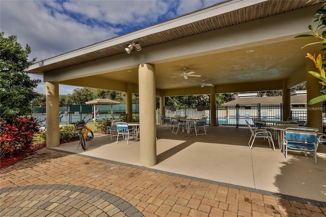 view of patio / terrace featuring a water view and ceiling fan