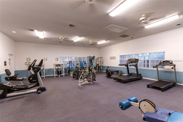 exercise room featuring ceiling fan and a textured ceiling