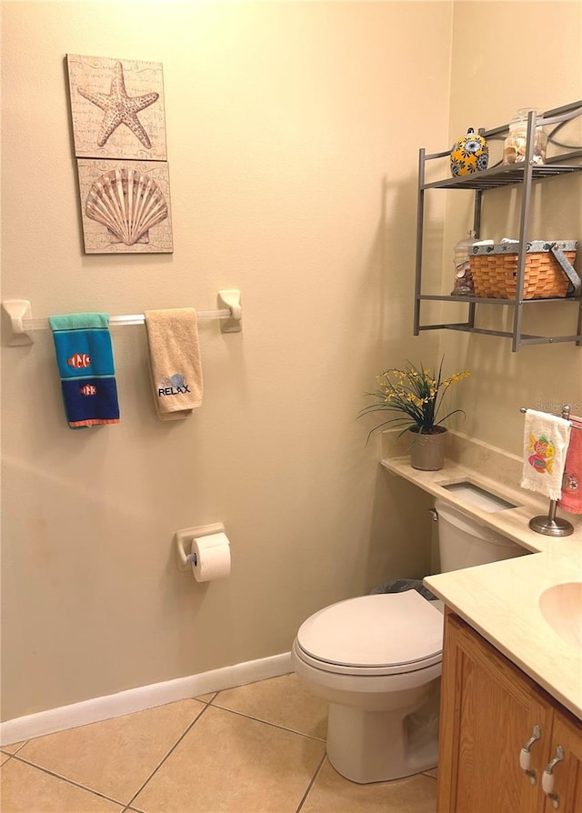 bathroom with tile patterned flooring, vanity, and toilet