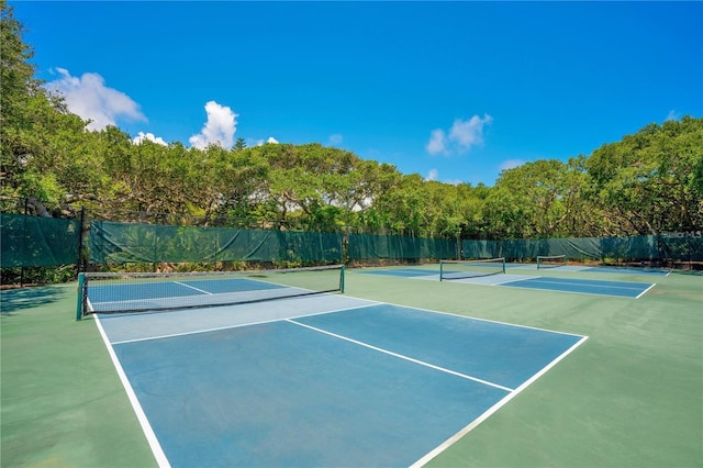 view of tennis court with basketball hoop