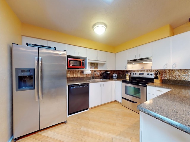 kitchen with sink, white cabinets, stainless steel appliances, and light hardwood / wood-style floors