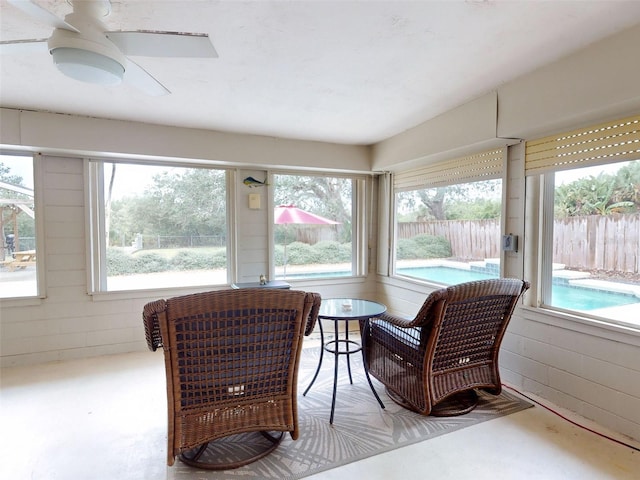 sunroom featuring ceiling fan