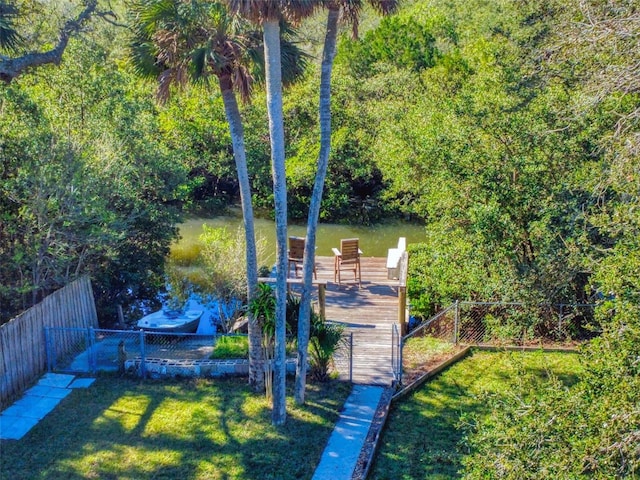 dock area with a yard and a water view