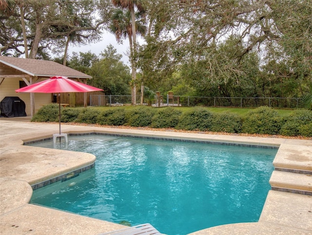 view of pool featuring grilling area and a patio