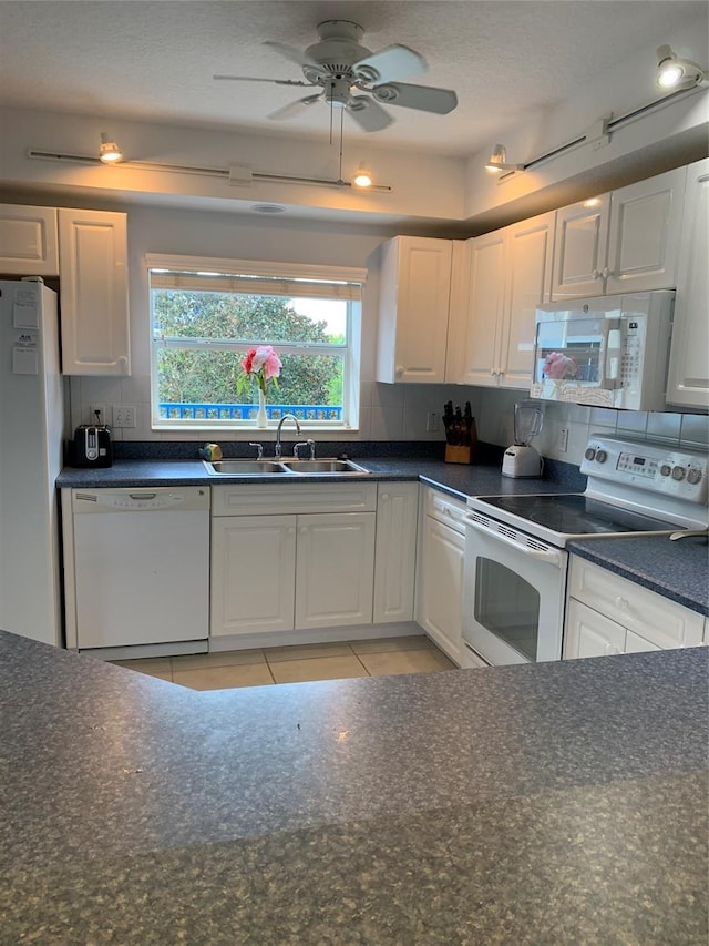 kitchen featuring light tile patterned floors, ceiling fan, white appliances, white cabinets, and sink