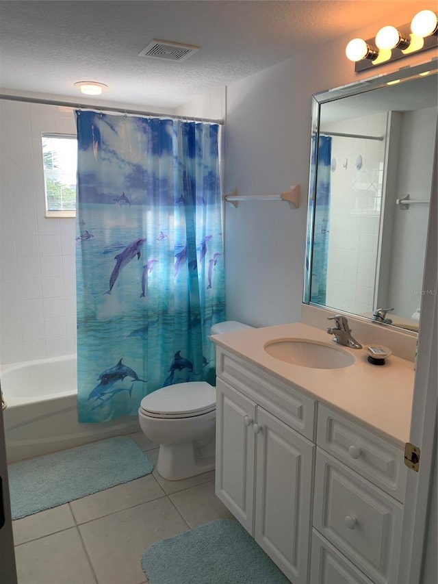 full bathroom with vanity, shower / tub combo with curtain, tile patterned floors, and a textured ceiling