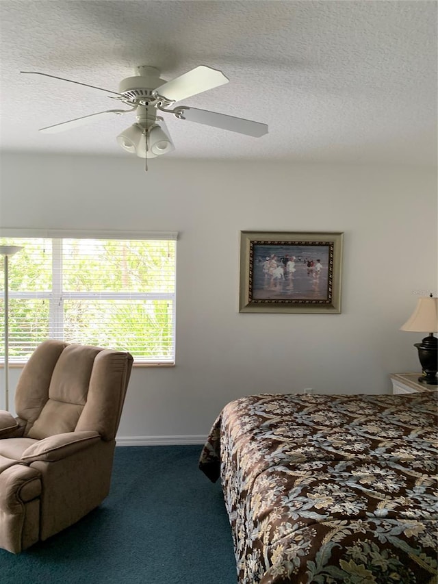 bedroom with a textured ceiling, ceiling fan, and carpet floors