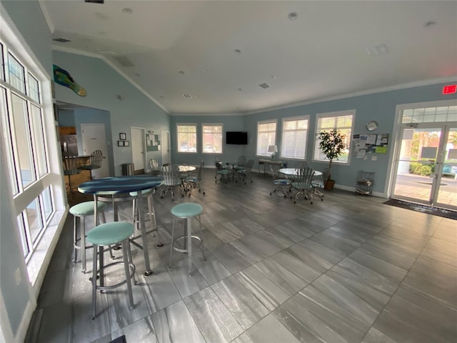 dining area with vaulted ceiling and ornamental molding