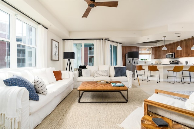 living room featuring light hardwood / wood-style floors and ceiling fan