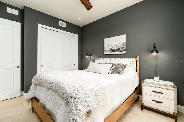 carpeted bedroom featuring a closet and ceiling fan