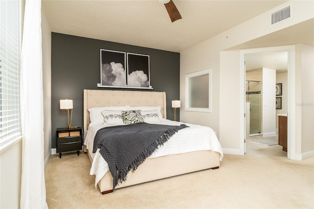 bedroom with carpet flooring, connected bathroom, and ceiling fan