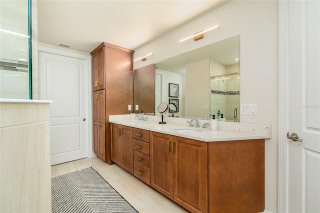 bathroom featuring vanity and an enclosed shower