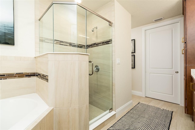 bathroom featuring vanity and plus walk in shower