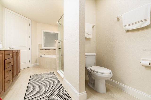 full bathroom featuring toilet, vanity, and separate shower and tub