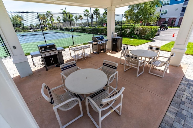 view of patio with tennis court and grilling area