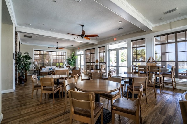 dining room with a textured ceiling, crown molding, ceiling fan, and dark wood-type flooring