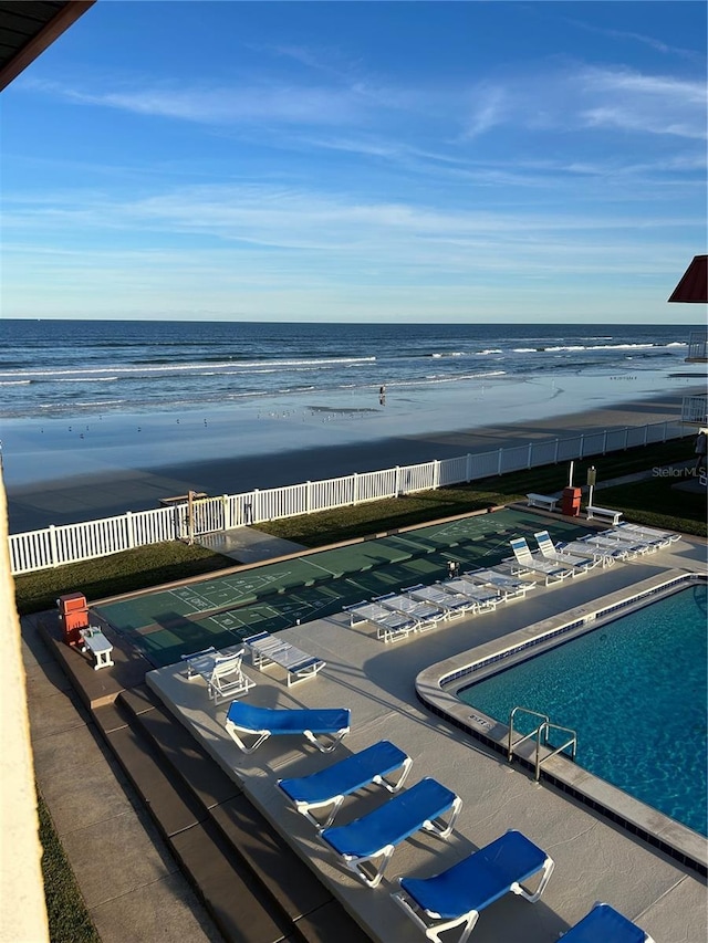 view of pool with a beach view and a water view