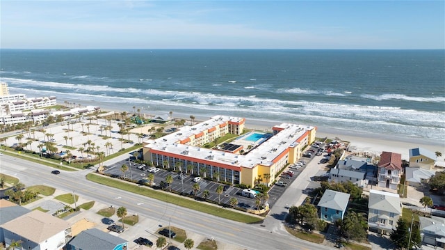 birds eye view of property with a beach view and a water view