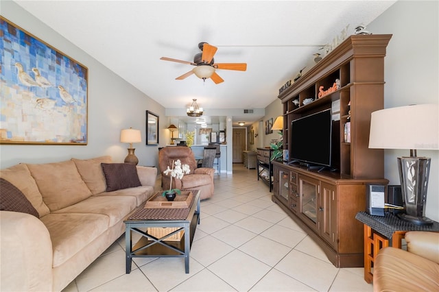 tiled living room with ceiling fan with notable chandelier