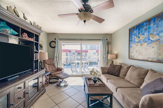 tiled living room with ceiling fan and a textured ceiling