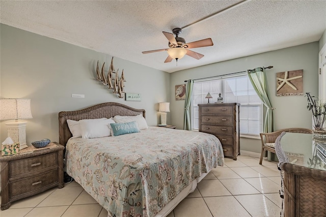 bedroom featuring light tile patterned floors, a textured ceiling, and ceiling fan