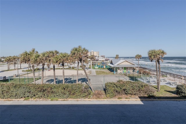 surrounding community with a view of the beach and a water view